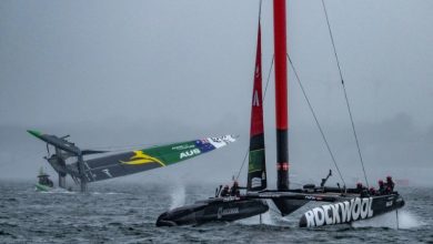 ROCKWOOL Denmark SailGP Team helmed by Nicolai Sehested sail past as the Australia SailGP Team F50 catamaran is towed upright after capsizing during the second race on Race Day 2 of the ROCKWOOL Canada Sail Grand Prix in Halifax, Canada - photo © Ricardo Pinto for SailGP